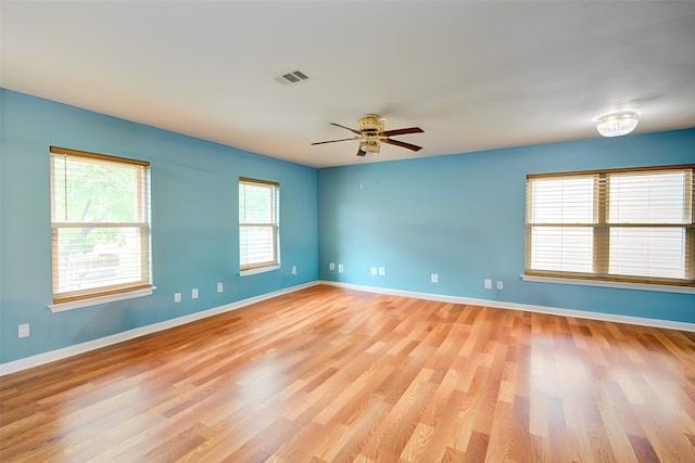 empty room with light wood-type flooring and ceiling fan