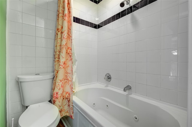 bathroom with shower / bath combo with shower curtain, toilet, and tile walls