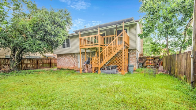 back of property with a deck and a lawn