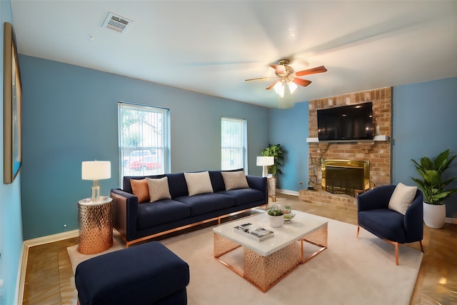 living room featuring a brick fireplace and ceiling fan