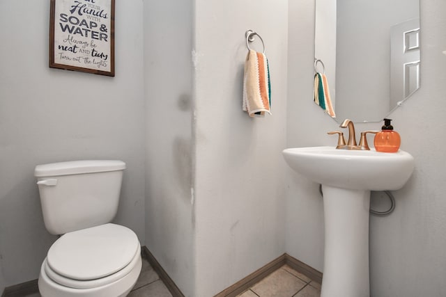 bathroom featuring tile patterned flooring and toilet