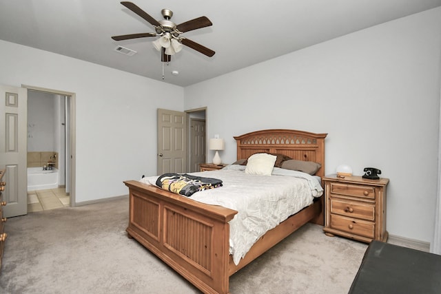 carpeted bedroom with connected bathroom and ceiling fan