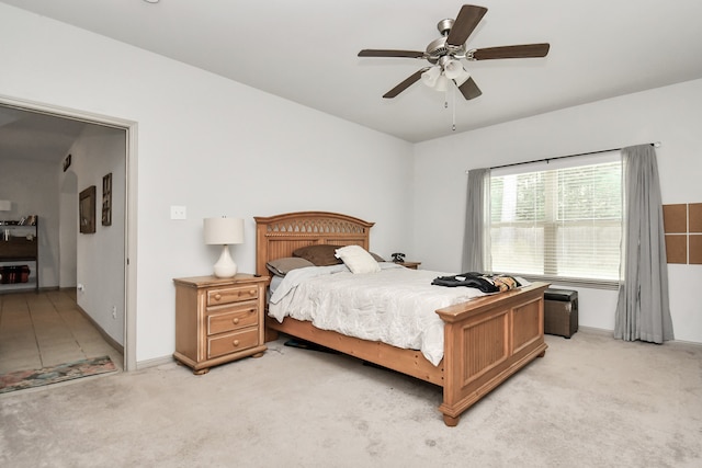 bedroom with ceiling fan and light colored carpet