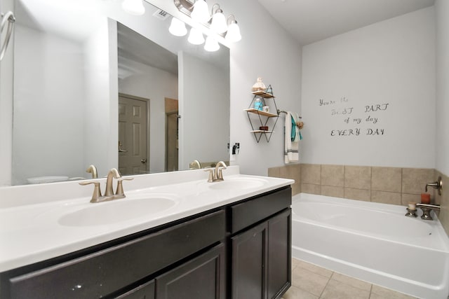 bathroom featuring dual vanity, tile patterned flooring, and a bath