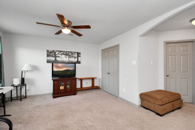 sitting room with light carpet and ceiling fan