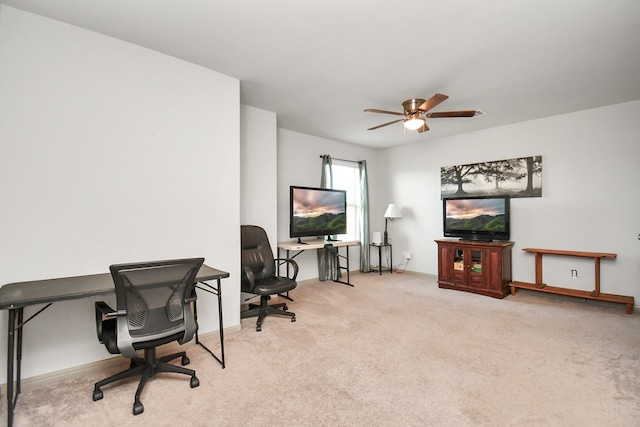 home office featuring light carpet and ceiling fan