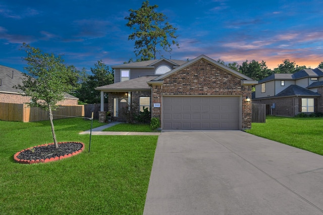 view of front of home featuring a garage and a lawn