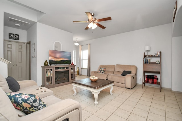 tiled living room with ceiling fan