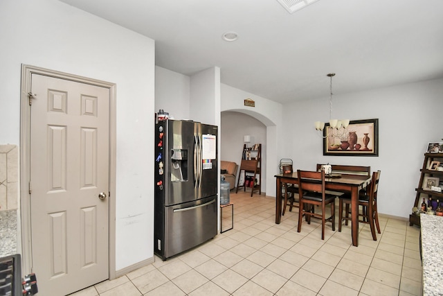 kitchen featuring hanging light fixtures, a notable chandelier, light tile patterned floors, and stainless steel fridge with ice dispenser