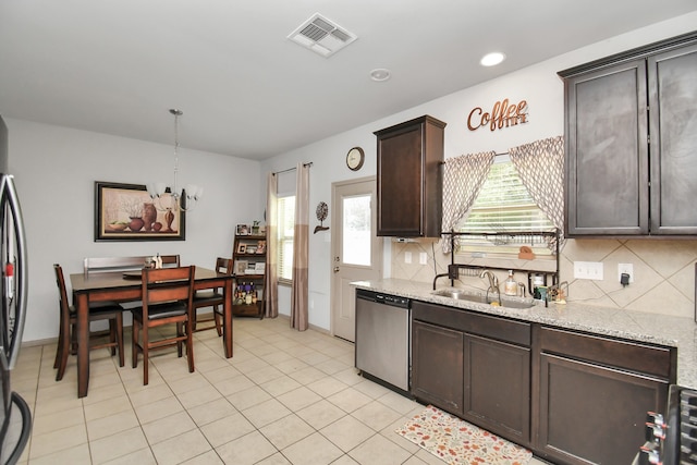 kitchen with tasteful backsplash, dark brown cabinets, sink, light stone counters, and dishwasher