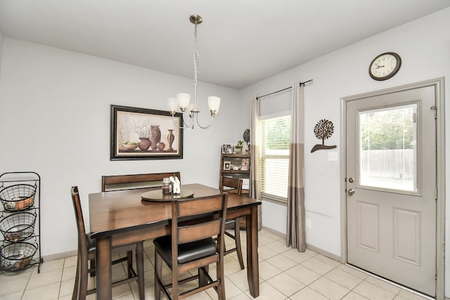 tiled dining area featuring an inviting chandelier