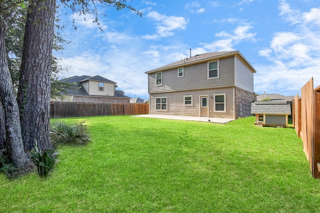 back of house featuring a yard and a patio