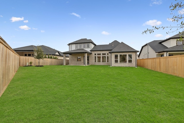 rear view of house with a lawn