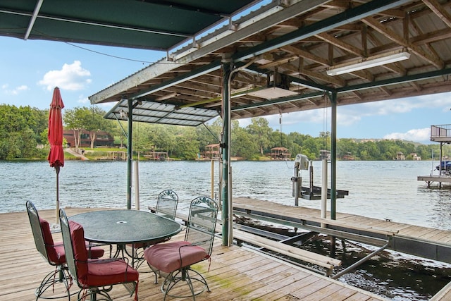 dock area featuring boat lift and a water view