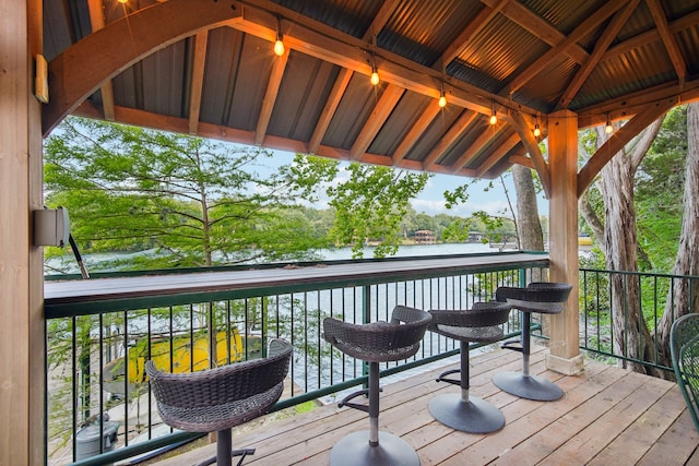 deck with a gazebo and a water view