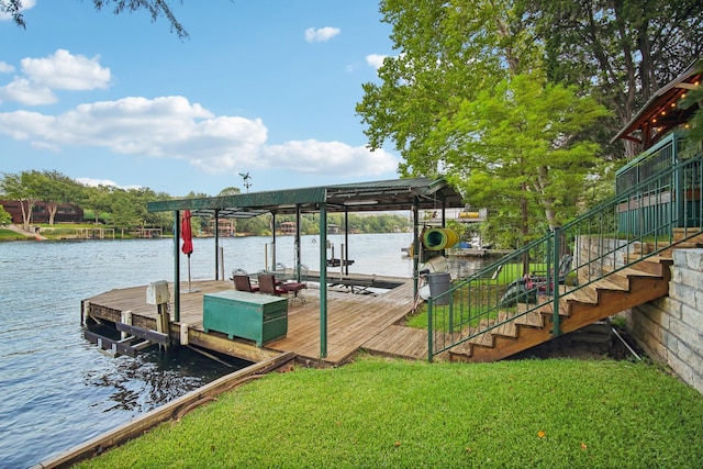 dock area with boat lift, a lawn, stairway, and a water view