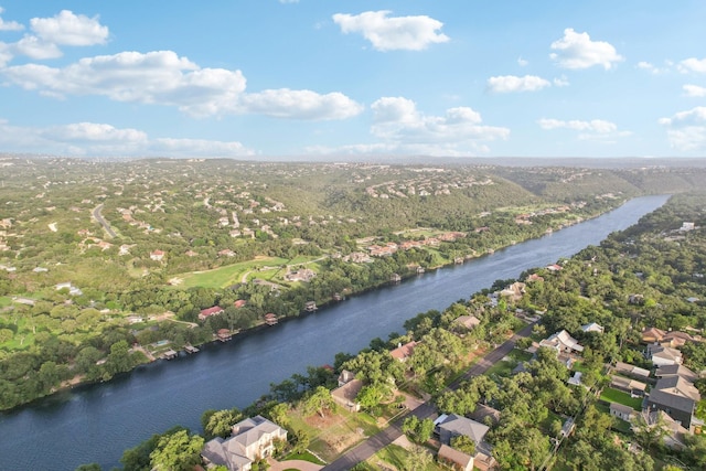 birds eye view of property featuring a forest view and a water view