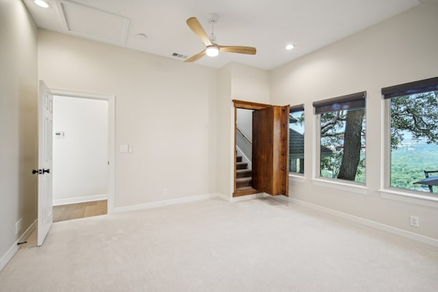 unfurnished room featuring light colored carpet and ceiling fan