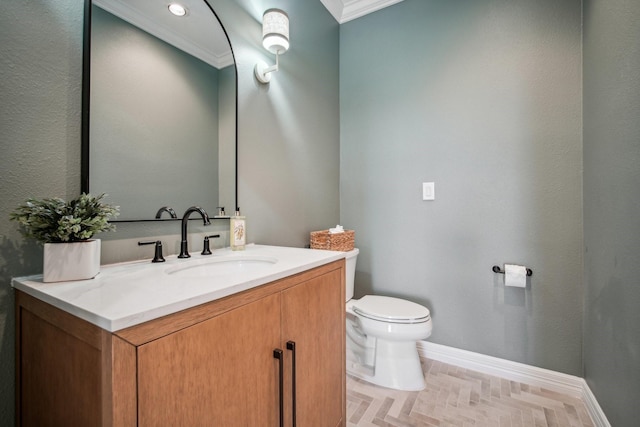 half bath with baseboards, toilet, vanity, and crown molding