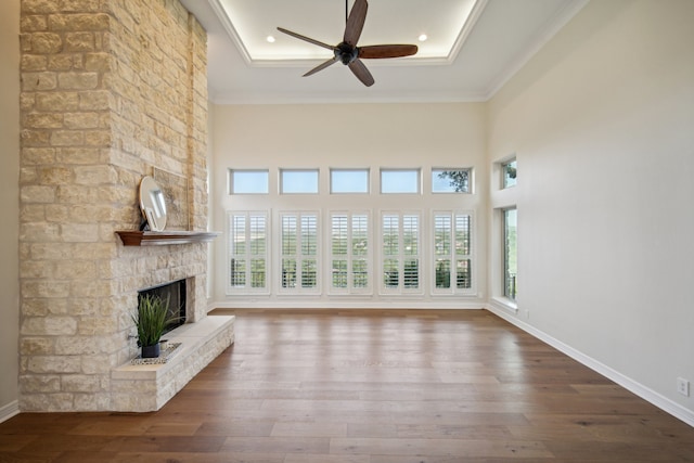 unfurnished living room with a fireplace, hardwood / wood-style flooring, plenty of natural light, and ornamental molding