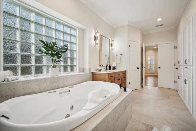 bathroom featuring vanity, tiled bath, and ornamental molding