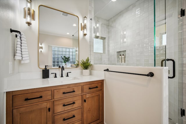 bathroom featuring vanity and a shower with shower door