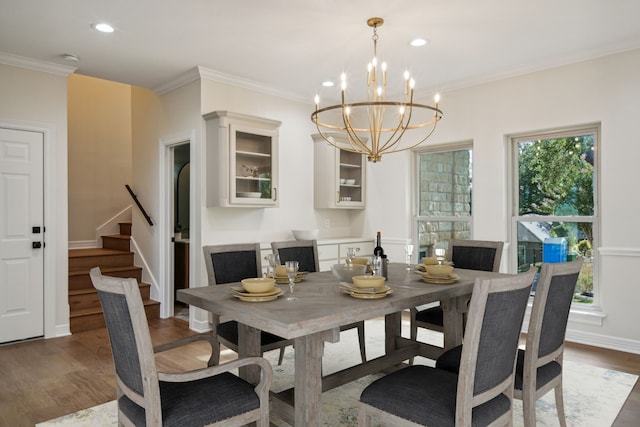 dining room with stairs, crown molding, recessed lighting, and wood finished floors