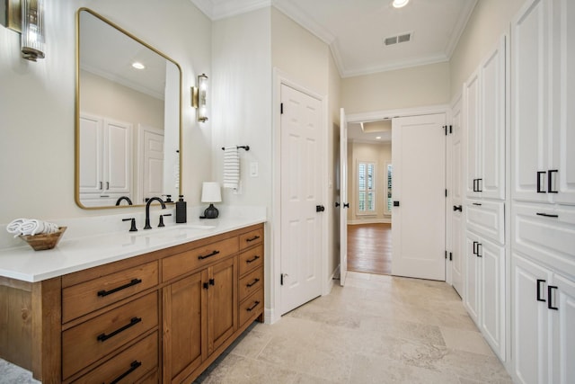 bathroom with recessed lighting, visible vents, vanity, and crown molding