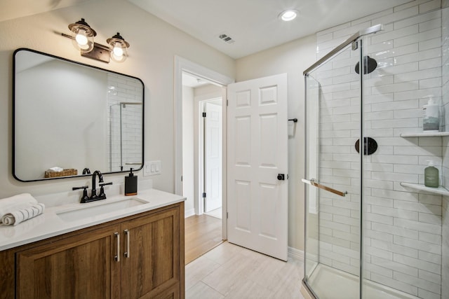 full bath with recessed lighting, visible vents, vanity, and a shower stall