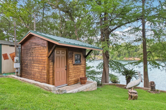 view of shed with a water view