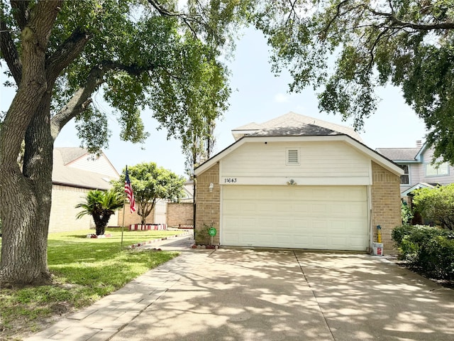 view of front of home with a garage and a front lawn