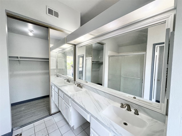 bathroom featuring dual vanity and wood-type flooring