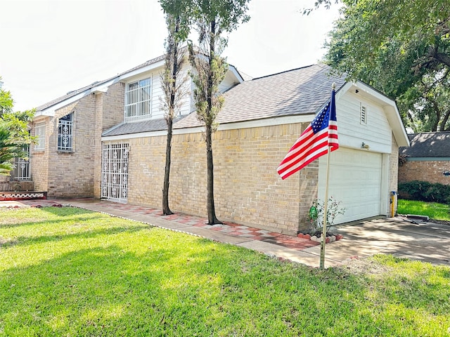 view of side of home featuring a garage and a lawn