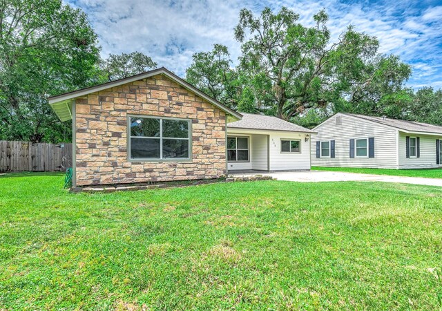 ranch-style house with a patio area and a front lawn