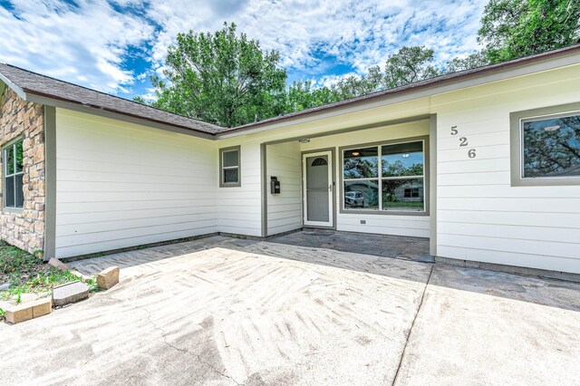 property entrance with a patio