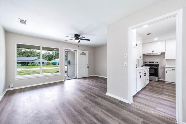 kitchen featuring ceiling fan, white cabinetry, hardwood / wood-style floors, and stainless steel range with electric stovetop