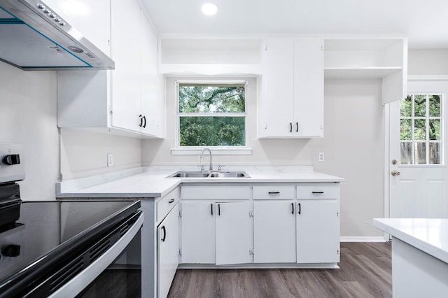 kitchen with white cabinetry, extractor fan, sink, and electric range