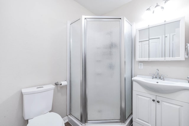 bathroom with vanity, toilet, and an enclosed shower