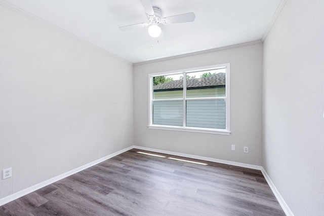 empty room with crown molding, dark hardwood / wood-style floors, and ceiling fan