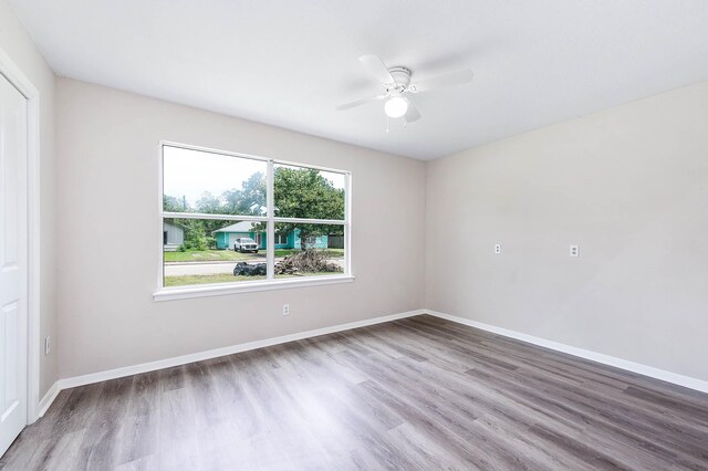 unfurnished room featuring ceiling fan and wood-type flooring