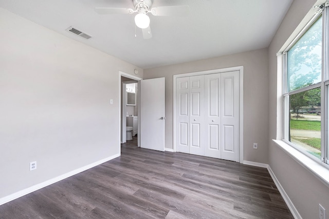 unfurnished bedroom featuring dark hardwood / wood-style floors, a closet, and ceiling fan