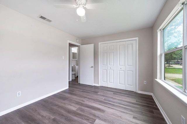 unfurnished bedroom featuring dark hardwood / wood-style flooring, a closet, and ceiling fan