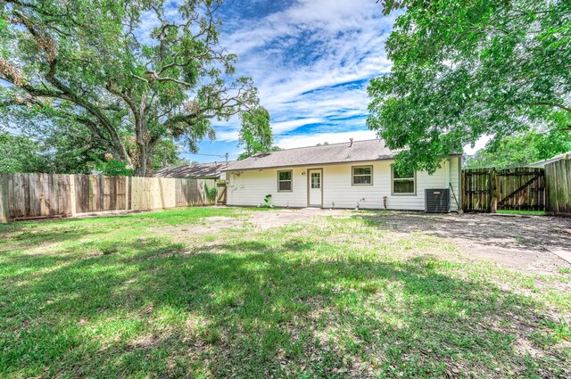 rear view of property featuring a yard