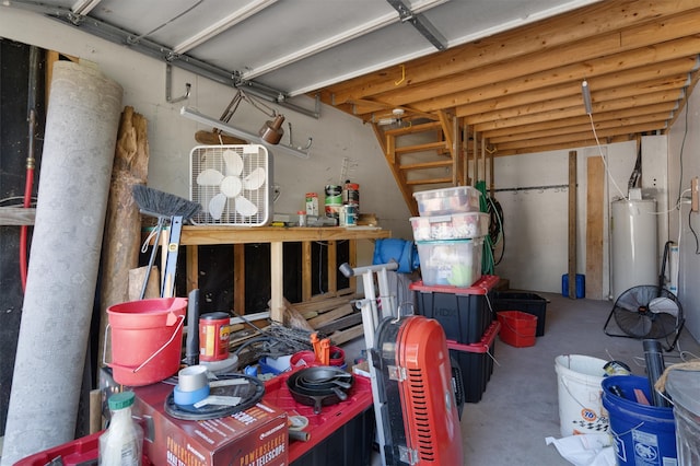 garage with a workshop area and water heater