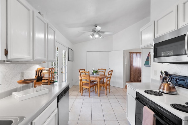 kitchen featuring stainless steel appliances, lofted ceiling, and white cabinetry