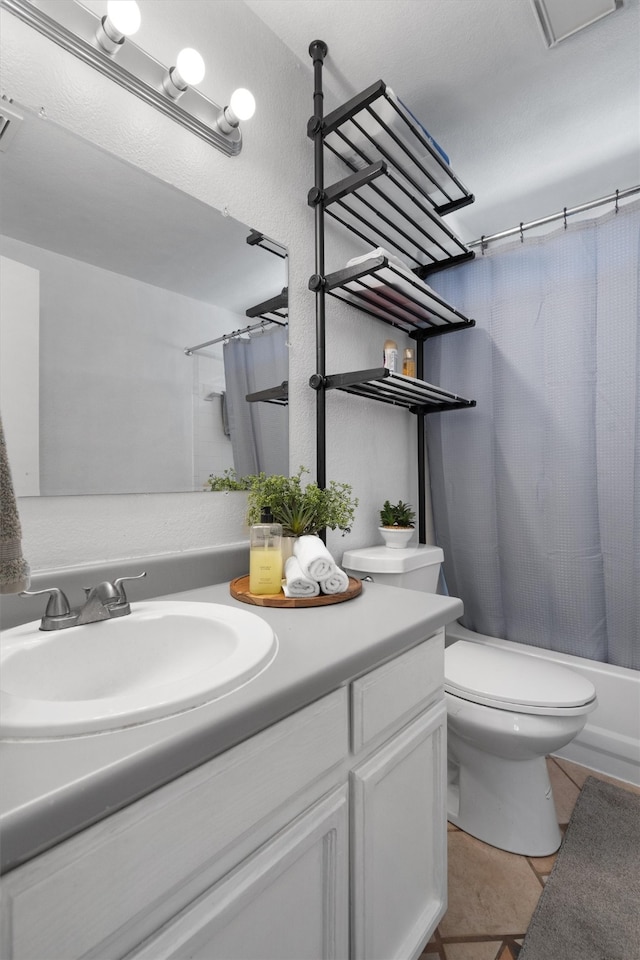 full bathroom featuring tile patterned floors, vanity, shower / tub combo, and toilet