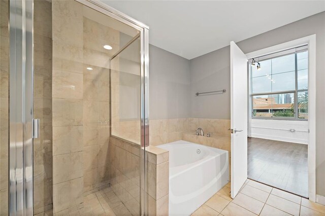 bathroom with tile patterned flooring and plus walk in shower