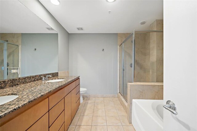 full bathroom with vanity, tile patterned flooring, plus walk in shower, and toilet