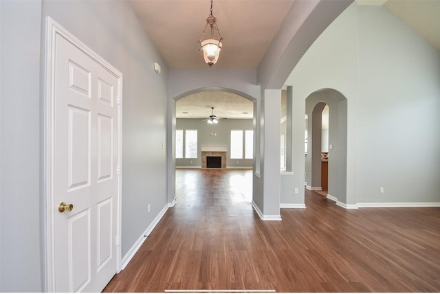 entrance foyer with ceiling fan, a towering ceiling, and dark hardwood / wood-style flooring