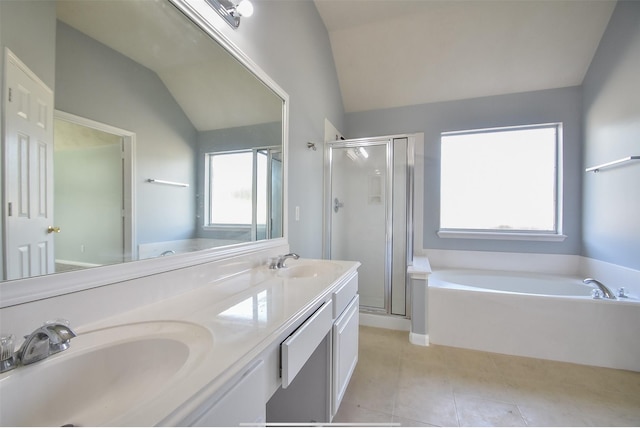 bathroom featuring tile patterned flooring, vaulted ceiling, shower with separate bathtub, and double sink vanity